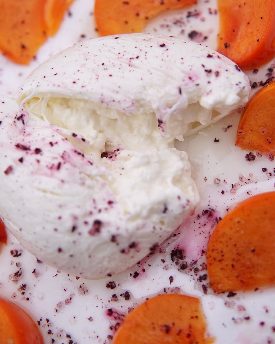 Shiso hibiscus infused salt on burratta and persimmon slices